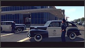 Po dotarciu do okolic miejsca zdarzenia omiń tarasujące drogę pojazdy policyjne #1 i podjedź do znanej z poprzednich śledztw zajezdni autobusowej, gdzie gra automatycznie wyświetli scenkę przerywnikową - Bus Stop Shooting | Przestępstwa w LA Noire - L.A. Noire - poradnik do gry