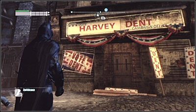 Odszukaj drzwi wejściowe do biura wyborczego Harveya Denta (powyższy screen) i zeskanuj je - Park Row - Zagadki słowne | Zagadki w Batman Arkham City - Batman: Arkham City - poradnik do gry
