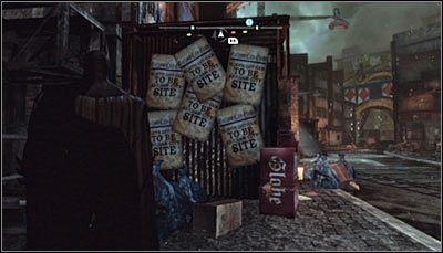 Odszukaj nieczynną budkę z hot-dogami (Bills Hotdogs) i zbadaj jej boczną ścianę - Dzielnica przemysłowa - Zagadki słowne, Kamery TYGERA | Zagadki - Batman: Arkham City - poradnik do gry