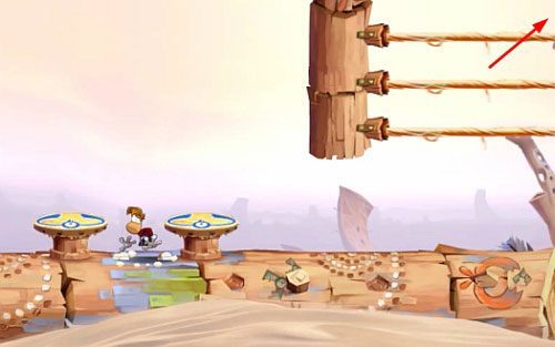 Po przejściu przez drzwi, za pierwszą struną znajdziesz roślinkę (3 L) - Szalone odbijanie (300 L, 1:30) | Pustynia Dijirdów | Rayman Origins - Rayman Origins - poradnik do gry