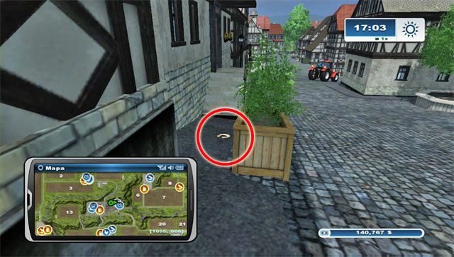 Podkowa jest w mieście schowana za drewnianą donicą w północnej pierzei budynków - Obszar E - podkowy 45 - 61 | Podkowy w Farming Simulator 2013 - Farming Simulator 2013 - poradnik do gry
