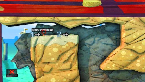 Gdy już tam będziemy podnosimy kolejny Elektromagnes [1], a następnie stawiamy go tak, by Mina [2] została zepchnięta w prawo - Plaża | Łamigłówki | Worms Revolution - Worms: Revolution - poradnik do gry