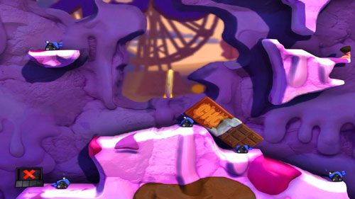 Kolejny raz stosujemy Telekinezę na tabliczce czekolady, tym razem lokując ją tak, by zasłoniła część Dział strażniczych [ilustracja] - Wszystkie atrakcje wesołego miasteczka! | Łamigłówki | Worms Revolution - Worms: Revolution - poradnik do gry