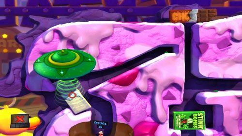 Naszego drugiego robala wykorzystujemy do przeniesienia tabliczki czekolady za pomocą UFO [ilustracja] - Wszystkie atrakcje wesołego miasteczka! | Łamigłówki | Worms Revolution - Worms: Revolution - poradnik do gry