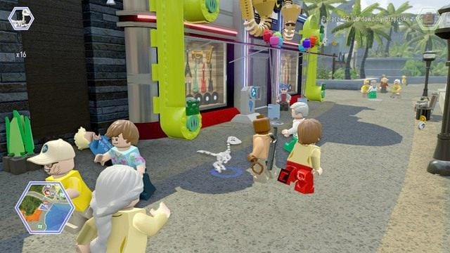 Podczas pobytu na ulicy, zmień postać na dinozaura kompsognata i wejdź do widocznych zielonych rur - Główna ulica | Jurassic World - sekrety - LEGO Jurassic World - poradnik gry