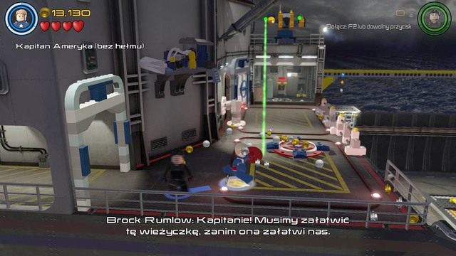 Będąc po drugiej stronie zacznij kontrolować Kapitana Amerykę i zawieś się na drążku, którego obiekt zasłania tarczę - Wizja do rewizji | Opis przejścia | LEGO Marvels Avengers - LEGO Marvels Avengers - poradnik do gry