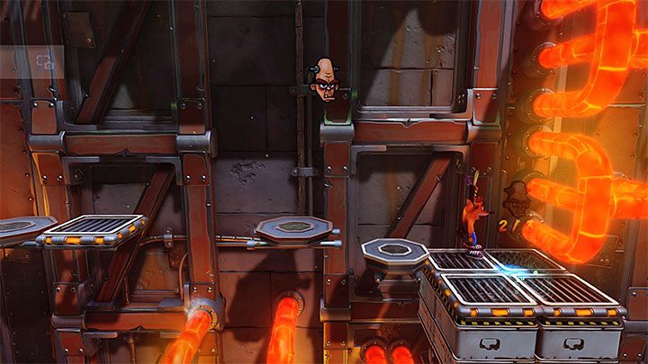 Podczas badania tej części fabryki zatrzymaj się na pokazanej na obrazku większej prawej półce - Heavy Machinery | Cortex Island | Opis przejścia | Crash N. Sane Trilogy - Crash Bandicoot N. Sane Trilogy - poradnik do gry