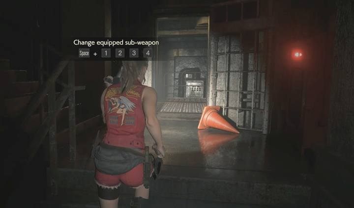 Skieruj się przez otwarte drzwi na piętrze niżej - Podziemia i pierwszy boss | Posterunek policji w Resident Evil 2 - Resident Evil 2 - poradnik do gry