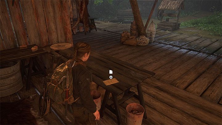 Dokument leży na drewnianym stole wewnątrz jednej z chatek - The Last of Us 2: Wyspa / The Island sekrety, znajdźki - The Last of Us 2 - poradnik do gry