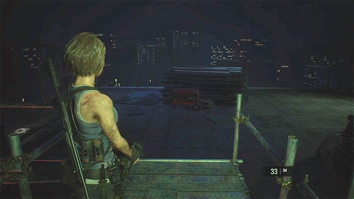 Walka rozpocznie się po zeskoczeniu z rusztowania na pokazany na obrazku dach - Resident Evil 3: Nemesis, miejsce rozbiórki - Resident Evil 3 - poradnik do gry
