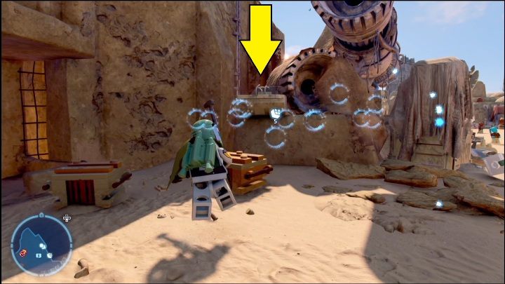 Klocek znajdujący się na północnej części regionu schowany jest za stosem części - LEGO Star Wars The Skywalker Saga: Mos Eisley - lista wszystkich łamigłówek - LEGO Skywalker Saga - poradnik do gry