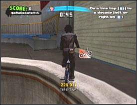 Młody Ryan czeka niedaleko baneru Tony Hawk Amjam - Vans skatepark #2 | Story mode | Tony Hawks American Wasteland - Tony Hawks American Wasteland - poradnik do gry