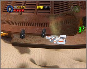 Gdy będziesz przy kolorowym mechanizmie na przedzie statku, użyj Ciemnej Strony na skrzynce, by stworzyć tarczę - Episode VI - The Great Pit of Carkoon | Freeplay Mode - LEGO Star Wars II: The Original Trilogy - poradnik do gry
