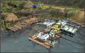 Po uzbieraniu 10 złotych skrzyń udaj się do zatoczki, rozbij je wszystkie i zbuduj z nich coś na wzór małej, mechanicznej tratwy - Superpremia | Kryształowa Czaszka Akt II | LEGO Indiana Jones 2 - LEGO Indiana Jones 2: The Adventure Continues - poradnik do gry